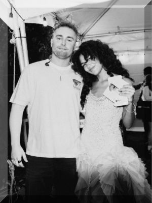 Sam Fender and Olivia Dean celebrate their record-breaking Number 1 single Rein Me In backstage at Lollapalooza, Chicago (credit: Lola Mansell)